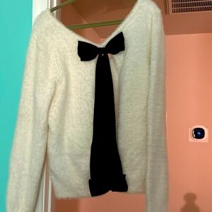 White and black sweater, open back